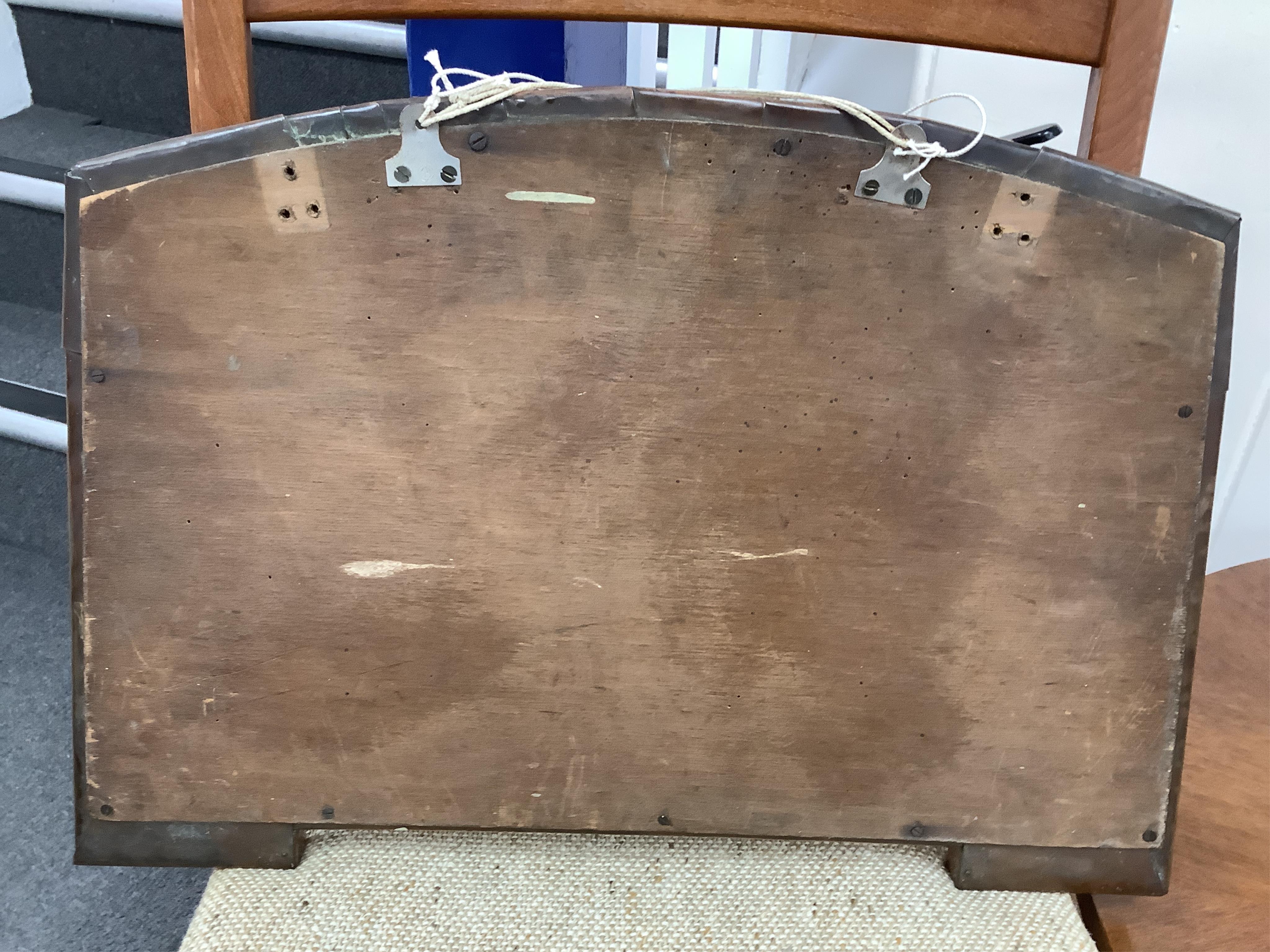 An Arts and Crafts riveted copper and Ruskin pottery cabochon inset mirror, 39cm high